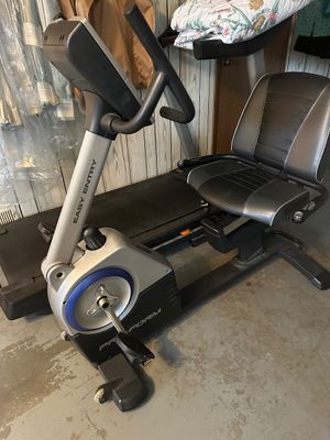 Sale Photo Thumbnail #47: ProForm Easy Entry recumbent exercise bike featuring a padded black vinyl seat, digital display console, and front transport wheels.