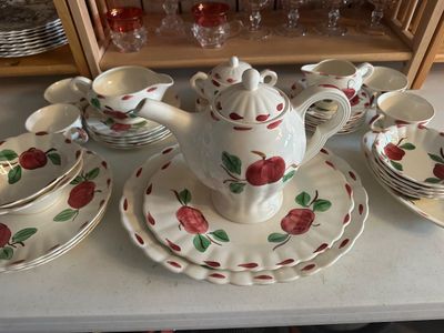 Sale Photo Thumbnail #53: Franciscan Apple pattern ceramic tea service and dishware, including a teapot, creamers, sugar bowl, cups, saucers, and plates.