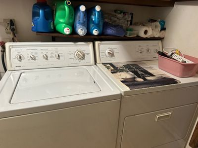 Sale Photo Thumbnail #33: Matching vintage Kenmore white washing machine and electric dryer, accompanied by a top shelf holding various laundry supplies.