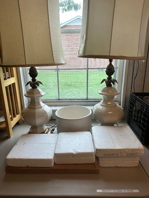 Sale Photo Thumbnail #43: Pair of vintage white ceramic table lamps with brass accents and beige fabric shades, displayed alongside a white ceramic bowl.