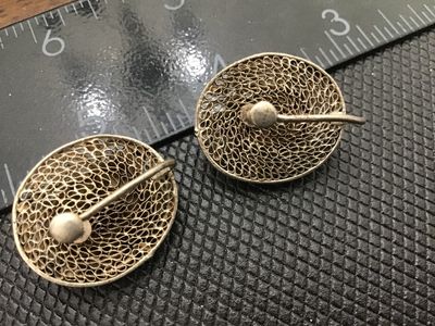 Sale Photo Thumbnail #77: Pair of vintage oval screw-back earrings featuring intricate silver wire filigree and beaded granulation work centered with polished reddish-orange carnelian cabochons. Show classic age patina with intact screw backs. Each measures approximately 3/4 inch 