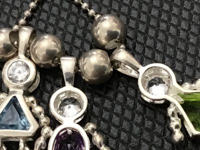 Sale Photo Thumbnail #69: Sterling silver ball chain necklace featuring three charming stick-figure girl pendants, each set with a clear top stone and colored gemstone bodies (blue, purple, and green). Stamped 925 on the chain clasp and pendant bails. 
925 Pendants 
- Material: St