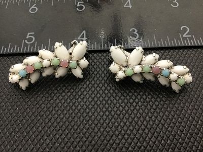 Sale Photo Thumbnail #49: Pair of vintage silver-tone clip-on earrings featuring white milk glass navette cabochons accented with small pastel-colored round cabochons/rhinestones (pink, green, and blue). Silver-tone metal backing with clip-on mechanisms in working order. Each earr