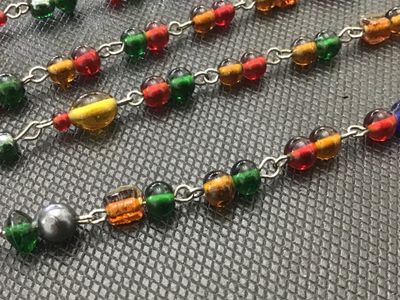 Sale Photo Thumbnail #222: Long vintage wire-wrapped chain necklace featuring colorful glass beads in shades of red, green, amber, blue, and yellow. The necklace measures approximately 24 inches in total length when doubled or extended. Shows light vintage wear appropriate for age 