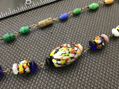 Sale Photo Thumbnail #42: A vintage colorful glass bead necklace featuring a mix of speckled multi-color 'end of day' style Murano glass beads along with wire-wrapped solid-colored glass accent beads. The necklace measures approximately 18 inches in total length and is finished wi
