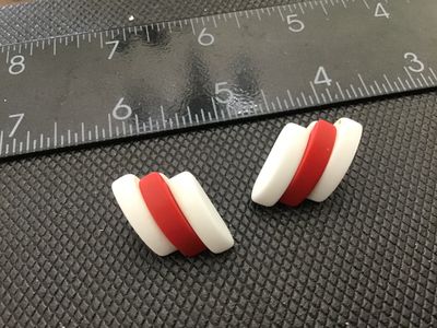 Sale Photo Thumbnail #31: Pair of vintage retro-style pierced post earrings featuring a bold diagonal striped design in opaque white and red plastic or resin. Measure approximately 1 inch in length based on ruler scale shown. Good vintage condition with post backs attached.