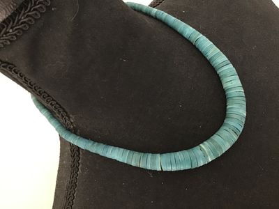Sale Photo Thumbnail #136: Single strand necklace featuring turquoise-colored disc/heishi style beads and small silver-tone accent beads near a barrel screw clasp. Good vintage condition with light wear consistent with age.