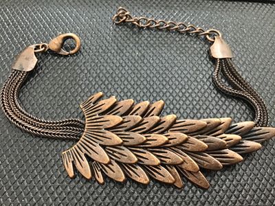 Sale Photo Thumbnail #108: Fashion costume bracelet featuring a multi-layered feather or scale centerpiece in a antique copper-tone finish. Attached to multi-strand wheat chain with a lobster claw clasp and adjustable extension chain. Good condition with light wear consistent with 