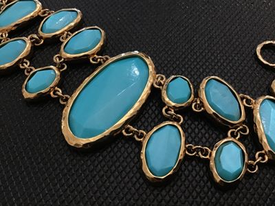 Sale Photo Thumbnail #199: Bold gold-tone link statement bracelet featuring textured, hammered-style bezel settings with bright turquoise-colored cabochons and faceted stones. Features a textured toggle closure. In good pre-owned condition with no  minor wear to the finish.