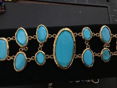 Sale Photo Thumbnail #203: Bold gold-tone link statement bracelet featuring textured, hammered-style bezel settings with bright turquoise-colored cabochons and faceted stones. Features a textured toggle closure. In good pre-owned condition with no  minor wear to the finish.