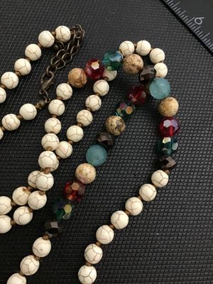 Sale Photo Thumbnail #227: Long beaded strand necklace featuring cream faux howlite/turquenite beads hand-knotted on cord, accented with multicolored faceted crystal, glass, and patterned stone beads. Includes a brass-tone lobster claw clasp and extender chain. Good pre-owned condi