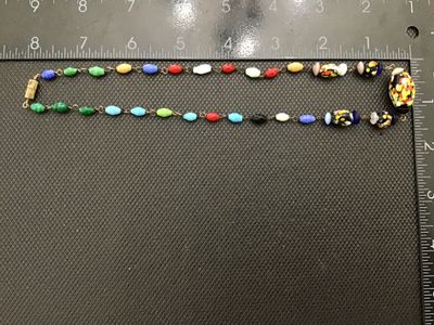 Sale Photo Thumbnail #46: A vintage colorful glass bead necklace featuring a mix of speckled multi-color 'end of day' style Murano glass beads along with wire-wrapped solid-colored glass accent beads. The necklace measures approximately 18 inches in total length and is finished wi