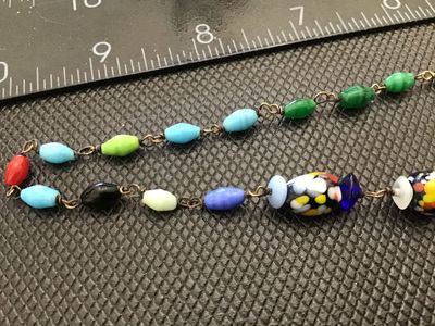 Sale Photo Thumbnail #43: A vintage colorful glass bead necklace featuring a mix of speckled multi-color 'end of day' style Murano glass beads along with wire-wrapped solid-colored glass accent beads. The necklace measures approximately 18 inches in total length and is finished wi