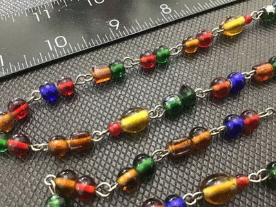 Sale Photo Thumbnail #220: Long vintage wire-wrapped chain necklace featuring colorful glass beads in shades of red, green, amber, blue, and yellow. The necklace measures approximately 24 inches in total length when doubled or extended. Shows light vintage wear appropriate for age 