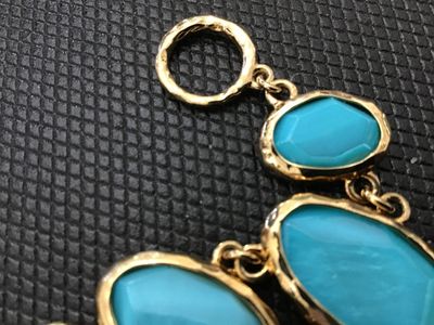 Sale Photo Thumbnail #201: Bold gold-tone link statement bracelet featuring textured, hammered-style bezel settings with bright turquoise-colored cabochons and faceted stones. Features a textured toggle closure. In good pre-owned condition with no  minor wear to the finish.