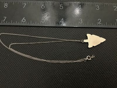 Sale Photo Thumbnail #24: Sterling silver chain necklace featuring an arrowhead-shaped pendant with crushed stone or resin inlay in turquoise blue and reddish-brown. The spring ring clasp and hang tag are stamped 'STERLING' and 'SWEET'. 

- Pendant Dimensions: Approx. 1.25 inches 