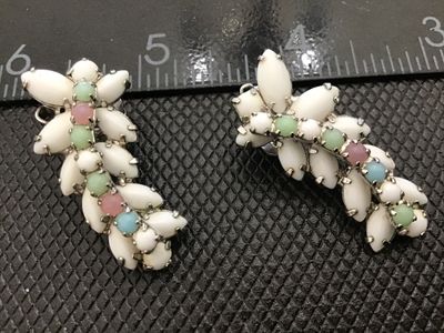 Sale Photo Thumbnail #47: Pair of vintage silver-tone clip-on earrings featuring white milk glass navette cabochons accented with small pastel-colored round cabochons/rhinestones (pink, green, and blue). Silver-tone metal backing with clip-on mechanisms in working order. Each earr