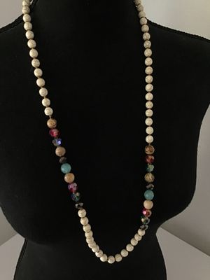 Sale Photo Thumbnail #226: Long beaded strand necklace featuring cream faux howlite/turquenite beads hand-knotted on cord, accented with multicolored faceted crystal, glass, and patterned stone beads. Includes a brass-tone lobster claw clasp and extender chain. Good pre-owned condi