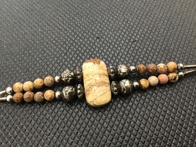 Sale Photo Thumbnail #170: Double-strand beaded bracelet featuring a rectangular picture jasper center stone, round picture jasper beads, decorative metallic accent beads, liquid silver-style tube beads, and a lobster claw clasp. Good pre-owned condition with light surface wear.