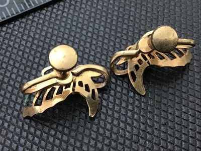 Sale Photo Thumbnail #103: Pair of vintage gold-tone screw-back earrings featuring an openwork butterfly design accented with three round blue rhinestones. Each earring measures approximately 3/4 inches long. Shows minor wear and patina consistent with age.