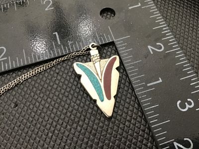 Sale Photo Thumbnail #25: Sterling silver chain necklace featuring an arrowhead-shaped pendant with crushed stone or resin inlay in turquoise blue and reddish-brown. The spring ring clasp and hang tag are stamped 'STERLING' and 'SWEET'. 

- Pendant Dimensions: Approx. 1.25 inches 