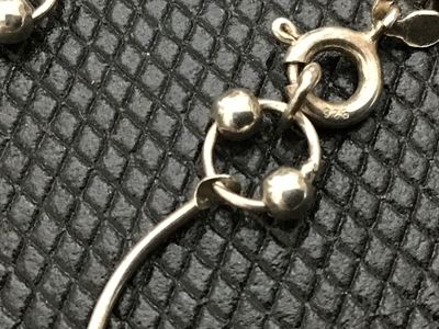 Sale Photo Thumbnail #95: A sterling silver link chain necklace featuring curved bar links accented with small bead charms. Stamped 925 near the spring ring clasp. Measures approximately 18 inches in total length when laid end to end. In good pre-owned condition with light tarnish