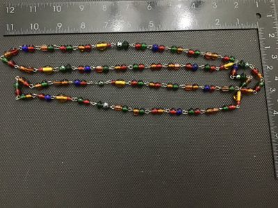 Sale Photo Thumbnail #221: Long vintage wire-wrapped chain necklace featuring colorful glass beads in shades of red, green, amber, blue, and yellow. The necklace measures approximately 24 inches in total length when doubled or extended. Shows light vintage wear appropriate for age 
