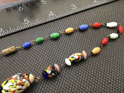 Sale Photo Thumbnail #44: A vintage colorful glass bead necklace featuring a mix of speckled multi-color 'end of day' style Murano glass beads along with wire-wrapped solid-colored glass accent beads. The necklace measures approximately 18 inches in total length and is finished wi