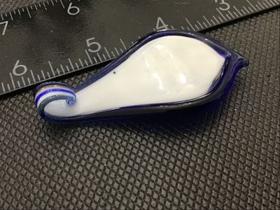 Sale Photo Thumbnail #218: Handmade art glass pendant featuring swirls of cobalt blue, opaque white, and gold aventurine glitter encased in clear glass. Measures approximately 2.5 inches in length by 1.25 inches in width. Includes an integrated glass loop at the top for hanging on 