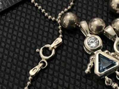Sale Photo Thumbnail #67: Sterling silver ball chain necklace featuring three charming stick-figure girl pendants, each set with a clear top stone and colored gemstone bodies (blue, purple, and green). Stamped 925 on the chain clasp and pendant bails. 
925 Pendants 
- Material: St
