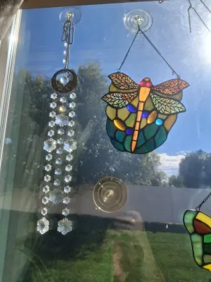 Sale Photo Thumbnail #372: LOT INCLUDES STAINED GLASS DRAGONFLY SUN CATCHER AND CRYSTAL PRISM WINDOW HANGING CHIME. GOOD CONDITION AND MORE.