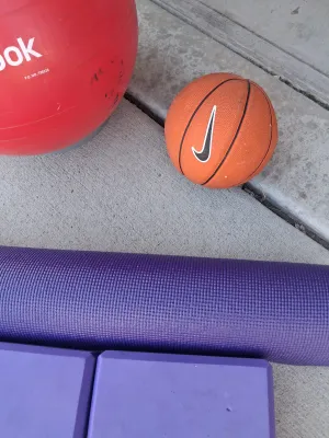 Sale Photo Thumbnail #202: REEBOK EXERCISE BALL, NIKE MINI BASKETBALL, EVOLAND UNDER DESK PEDAL EXERCISER, PURPLE YOGA MAT, TWO FOAM BLOCKS, CANVAS CARRY BAG, AND MORE. ALL ITEMS SHOW LIGHT SIGNS OF USE.