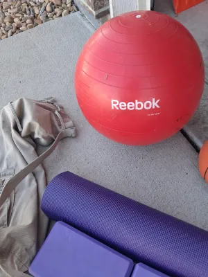 Sale Photo Thumbnail #201: REEBOK EXERCISE BALL, NIKE MINI BASKETBALL, EVOLAND UNDER DESK PEDAL EXERCISER, PURPLE YOGA MAT, TWO FOAM BLOCKS, CANVAS CARRY BAG, AND MORE. ALL ITEMS SHOW LIGHT SIGNS OF USE.