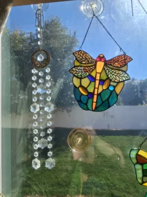 Sale Photo Thumbnail #375: LOT INCLUDES STAINED GLASS DRAGONFLY SUN CATCHER AND CRYSTAL PRISM WINDOW HANGING CHIME. GOOD CONDITION AND MORE.
