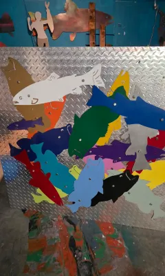 Sale Photo Thumbnail #43: Large diamond plate metal wall art panel featuring colorful painted cutouts of fish.