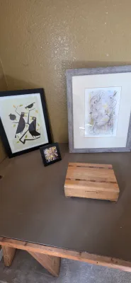 Sale Photo Thumbnail #30: Collection of tabletop decor including a mid-century modern style bird art print, an abstract framed watercolor, a small square starburst art piece, and a wooden trinket box.