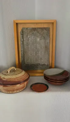 Sale Photo Thumbnail #20: Collection of studio pottery including a lidded casserole dish, small dishes, and a framed relief art piece.