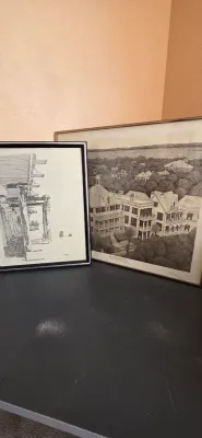 Sale Photo Thumbnail #29: Two framed black and white architectural and landscape prints resting against a wall.