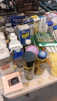 Sale Photo Thumbnail #27: Assortment of household cleaning supplies, pesticides, and garage essentials, including Bar Keepers Friend, Raid flea spray, and Everbrite crystal clear coating.