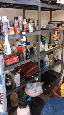 Sale Photo Thumbnail #11: Multi-tier plastic garage shelving unit filled with various automotive fluids, spray paints, cleaning supplies, and small tools.