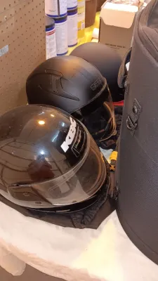 Sale Photo Thumbnail #21: Collection of black motorcycle helmets, including a glossy KBC full-face helmet and matte finish open-face helmets with visors.