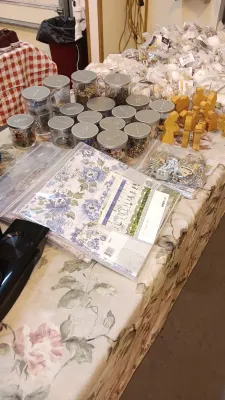 Sale Photo Thumbnail #40: Collection of crafting supplies including clear jars filled with beads and embellishments, paper craft pads, and wooden nativity figures.