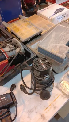 Sale Photo Thumbnail #14: Vintage Porter-Cable router alongside various small parts organizers and power tools on a workbench.
