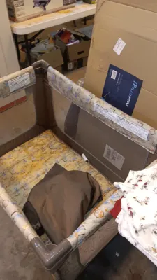 Sale Photo Thumbnail #42: Portable mesh baby playpen featuring a patterned yellow padded mattress base and brown frame.