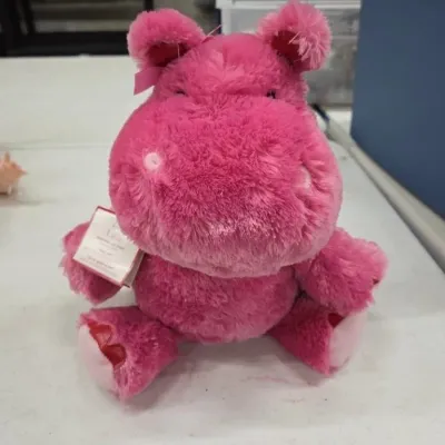 Plush bright pink hippo stuffed animal with original Hallmark store tag attached.
