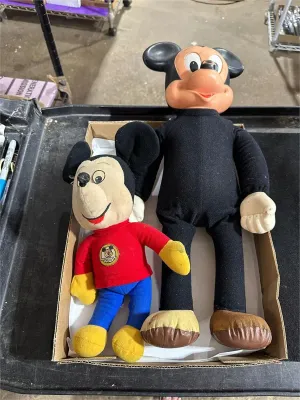 Pair of vintage Mickey Mouse dolls resting inside a cardboard box, including a plush Mickey Mouse Club figure and a larger vinyl-headed...