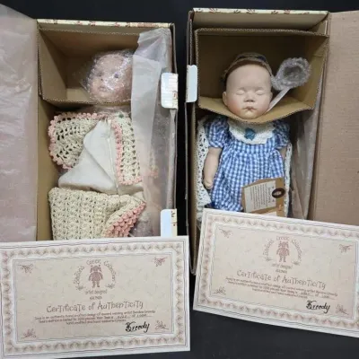 Pair of Barton's Creek Collection artist-designed Gund porcelain dolls, complete with original boxes and certificates of authenticity.