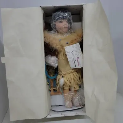 Duck House Heirloom Dolls Native American style porcelain doll, packaged in original box with certificates and protective wrapping.
