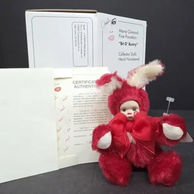 Marie Osmond Fine Porcelain "Bit O' Bunny" Cran-Bunny collector doll in a red fuzzy bunny suit, complete with original box...