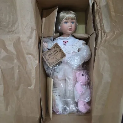 Vintage Boyds Collection porcelain doll with original box, hangtag, and small pink teddy bear accessory.